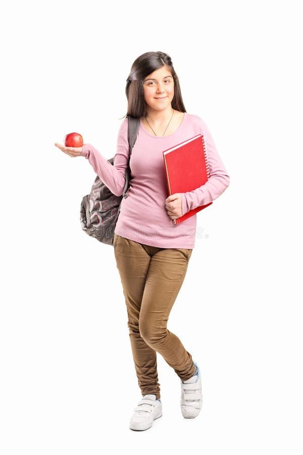 Schoolgirl holding an apple stock images