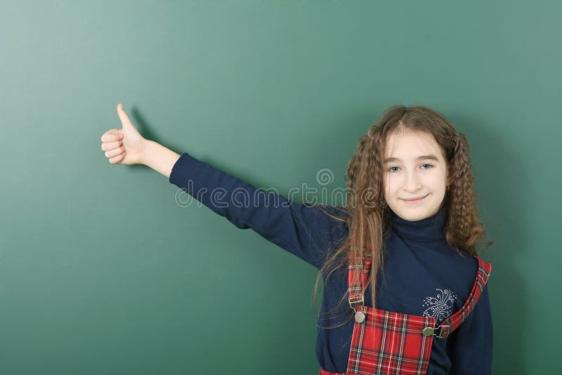 Schoolgirl Near Green School Board Young Playful Girl Shows A Finger Up Stock Image Image Of 