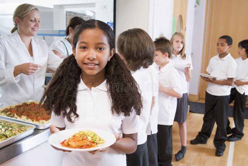 Schoolgirl in a school cafeteria royalty free stock images