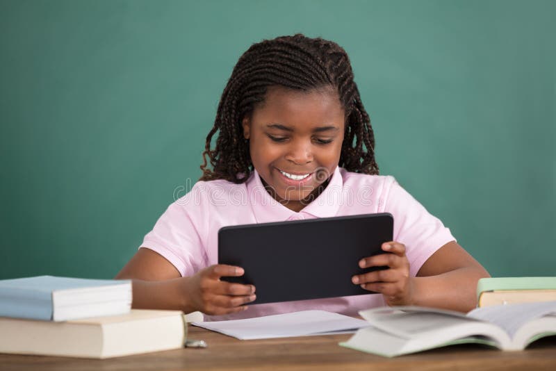 Schoolgirl Using Digital Tablet stock photo