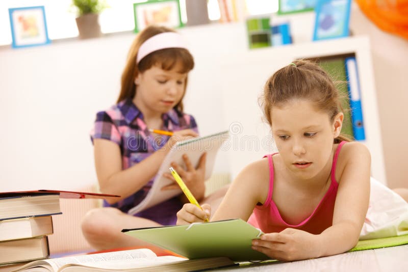 Schoolgirls doing homework stock photos