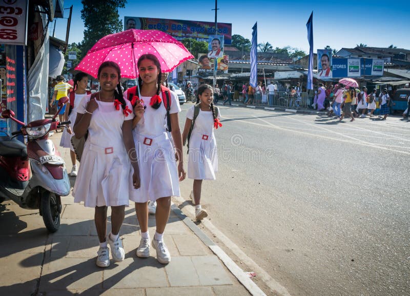 Sri Lankan school girls walk on the shores of Galle Face 