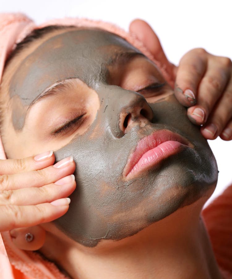 Beauty-spa. Applying of cosmetic mud mask. Close face of young woman. Beauty-spa. Applying of cosmetic mud mask. Close face of young woman