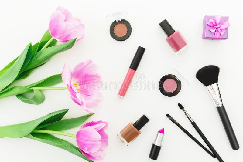 Beauty composition with pink tulips bouquet, cosmetics and gift box on white background. Top view. Flat lay home desk. Beauty composition with pink tulips bouquet, cosmetics and gift box on white background. Top view. Flat lay home desk.