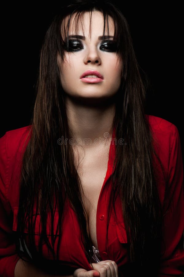 Beauty female with smoky eyes and red blouse. Beauty female with smoky eyes and red blouse