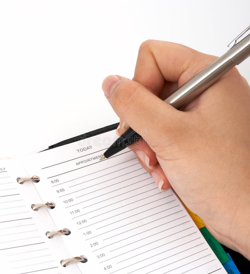Schreiben auf einen Organisator stockfotografie Schreiben auf einen Organisator stockfotografie