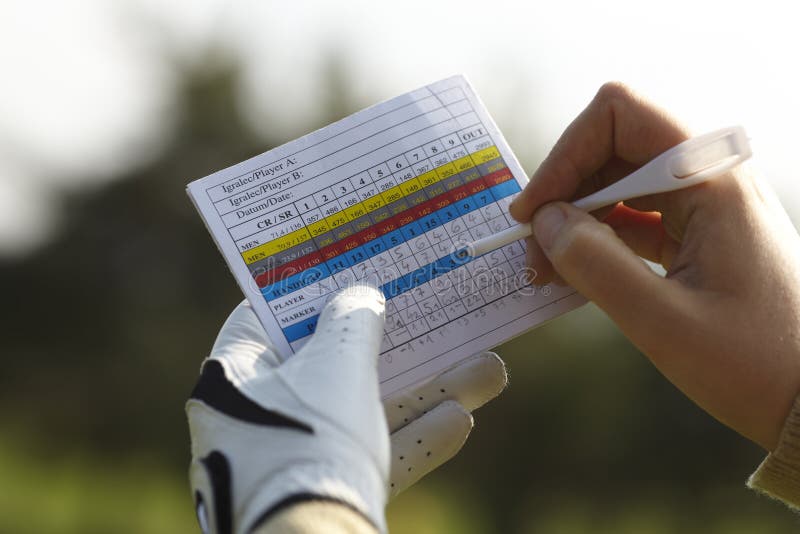 Writing golf handicap with a glove. Writing golf handicap with a glove.
