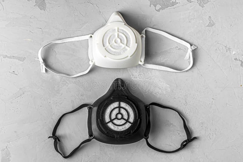 black and white protective mask is printed on a 3D printer. protection from virus, coronavirus top view flat lay layot with copy space. black and white protective mask is printed on a 3D printer. protection from virus, coronavirus top view flat lay layot with copy space