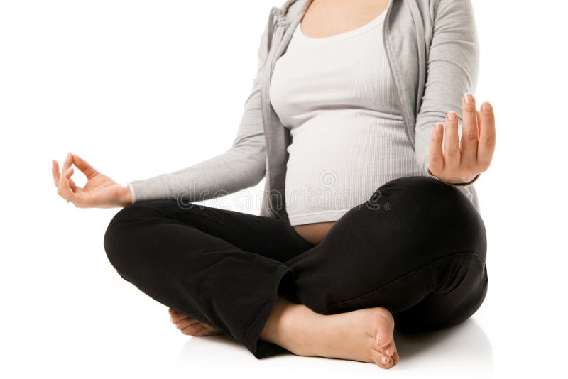 Pregnant woman relax doing yoga, sitting in lotus position over white background. Pregnant woman relax doing yoga, sitting in lotus position over white background.