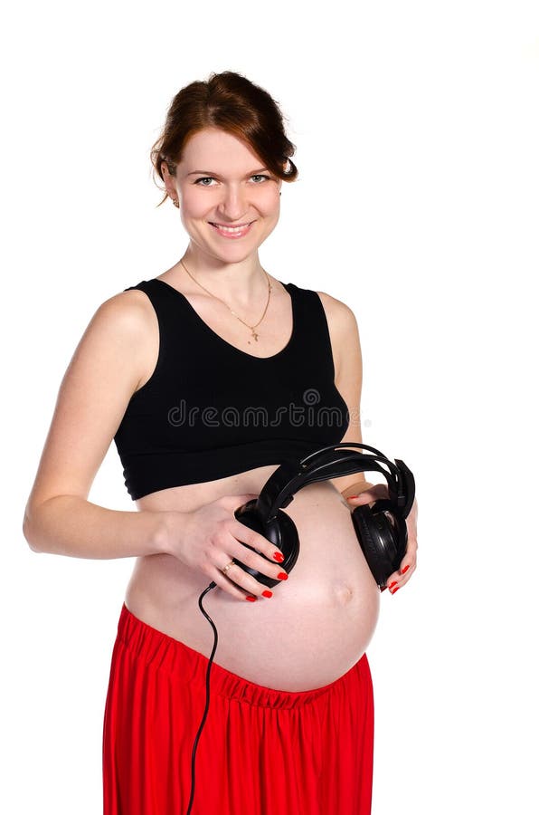 Schwangere haltene Kopfhörer nähern sich Bauch stockbilder Schwangere haltene Kopfhörer nähern sich Bauch stockbilder
