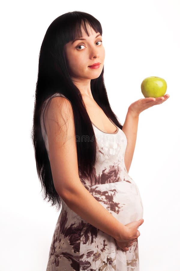 Schwangeres Mädchen der Junge isst einen Apfel. lizenzfreie stockfotografie Schwangeres Mädchen der Junge isst einen Apfel. lizenzfreie stockfotografie