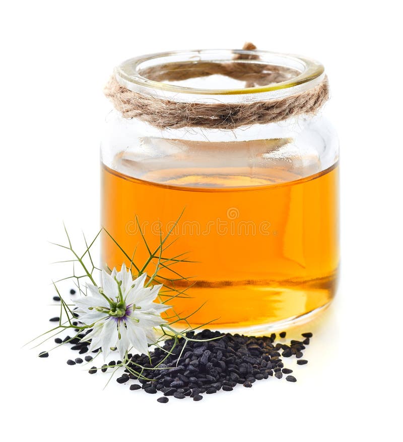 Schwarzkümmelöl mit Blume und Samen lizenzfreie stockfotos