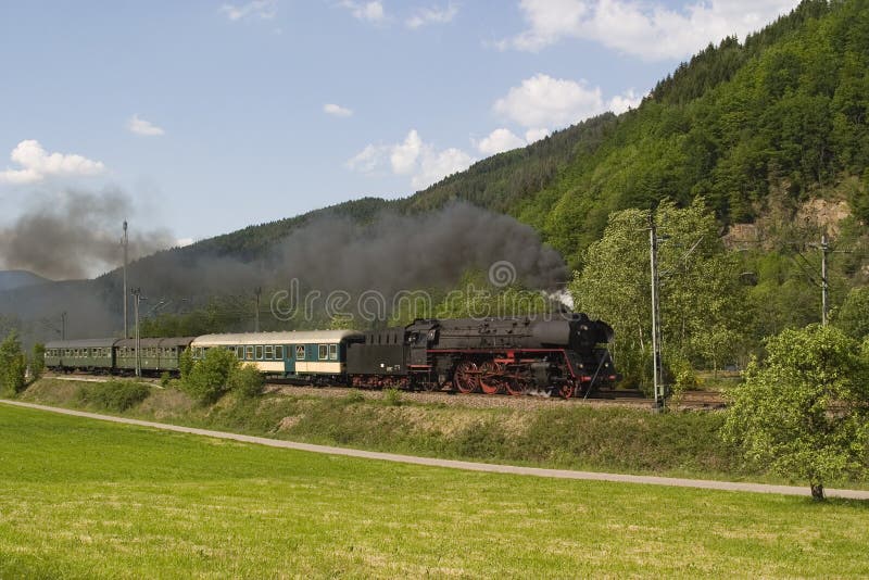 Historic high speed steam train 01-519 on the tracks of the Schwarzwaldbahn line, through a romantic valley in the Black forest, Germany.