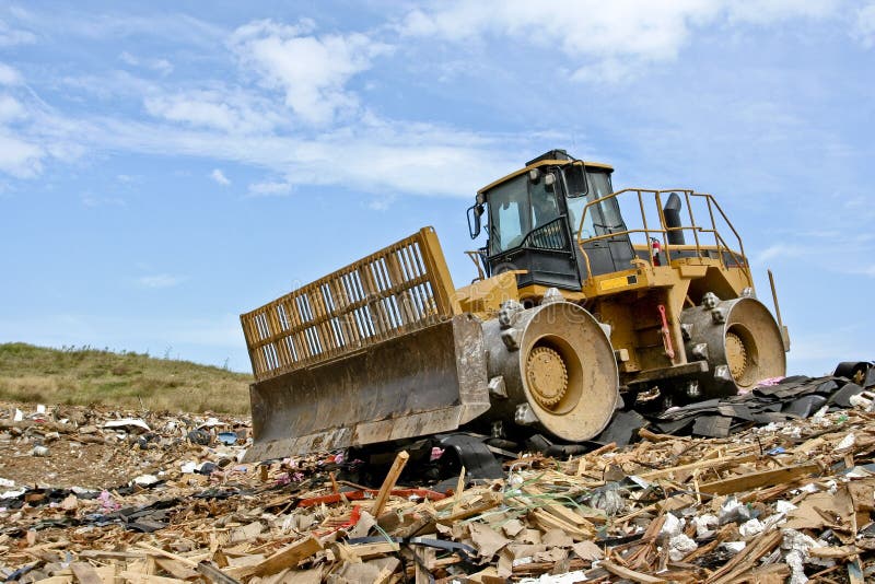 A compactor on debris in a landfill. A compactor on debris in a landfill.