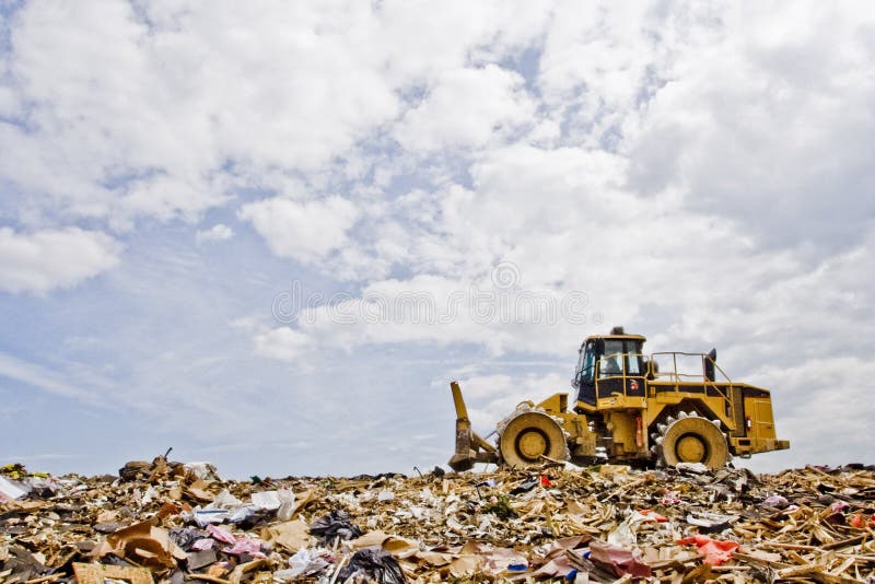 A Compactor working over trash at a landfill. A Compactor working over trash at a landfill.