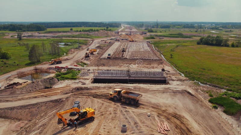 Heavy earthmoving machinery on a huge road construction site. Long-reach excavators, bulldozers, dump trucks. Warsaw, Poland. High quality photo. Heavy earthmoving machinery on a huge road construction site. Long-reach excavators, bulldozers, dump trucks. Warsaw, Poland. High quality photo