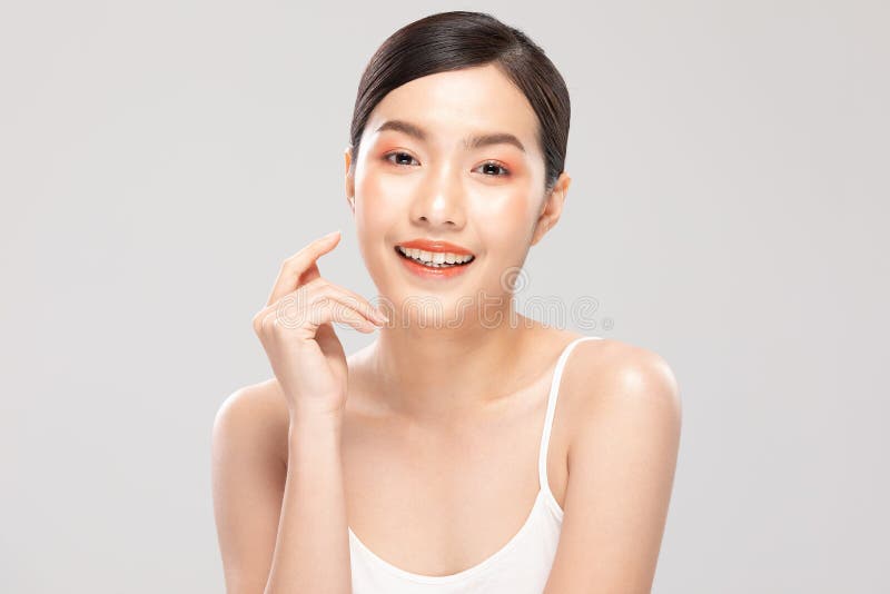 Schöne asiatische junge Frau, die Soft Power Backenlächeln mit sauberer frischer Haut berührt. Schöne asiatische junge Frau, die Soft Power Backenlächeln mit sauberem Neu Hautglück berühren und nett mit dem Positiven emotional auf weißen Hintergrundschönheitskosmetik und Gesichtsbehandlungskonzept
