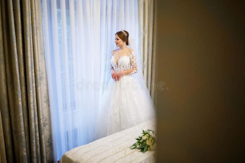 Schöne Brautkleidung mit ihrem weißen Hochzeitskleid stockfotografie