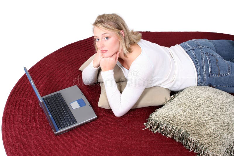 Beautiful 21 year old blonde with blue eyes laying on the floor with a laptop computer. Shot with the Canon 20D. Beautiful 21 year old blonde with blue eyes laying on the floor with a laptop computer. Shot with the Canon 20D.