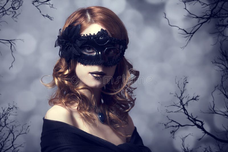 Beautiful woman in carnival mask. Photo with forest at background. Beautiful woman in carnival mask. Photo with forest at background