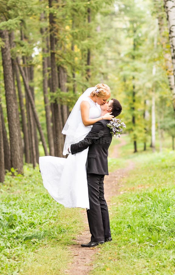 Schöne Hochzeitspaare im Park Sie küssen und umarmen sich stockfotos Schöne Hochzeitspaare im Park Sie küssen und umarmen sich stockfotos