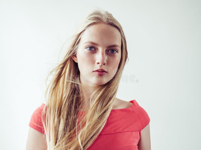 Beautiful long blonde hair woman in red dress natural over white background. Studio shot. Beautiful long blonde hair woman in red dress natural over white background. Studio shot