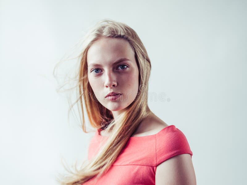 Beautiful long blonde hair woman in red dress natural over white background. Studio shot. Beautiful long blonde hair woman in red dress natural over white background. Studio shot