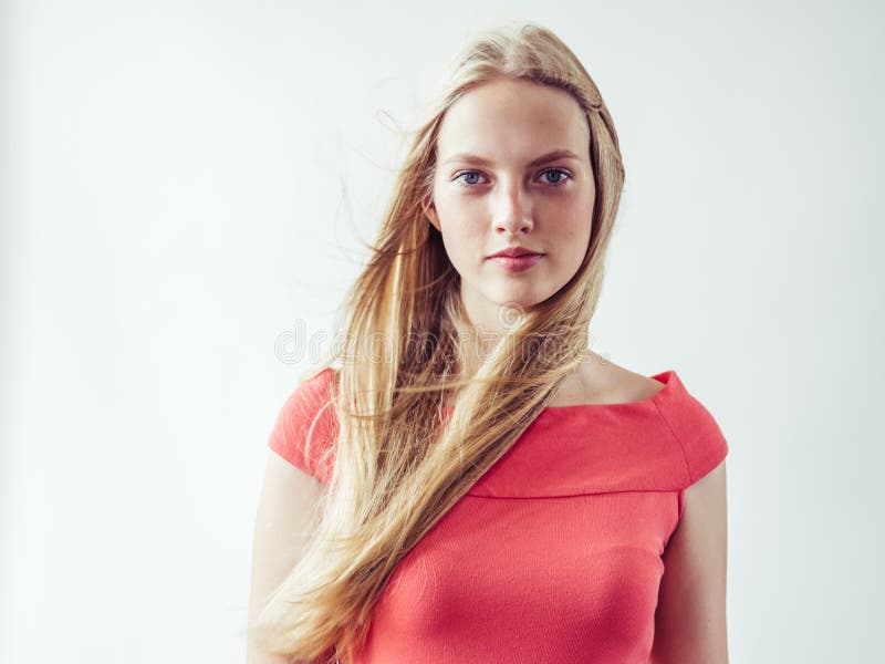 Beautiful long blonde hair woman in red dress natural over white background. Studio shot. Beautiful long blonde hair woman in red dress natural over white background. Studio shot