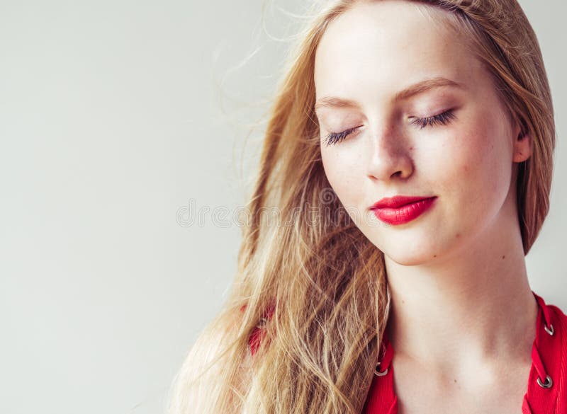 Beautiful long blonde hair woman in red dress natural over white background. Studio shot. Beautiful long blonde hair woman in red dress natural over white background. Studio shot