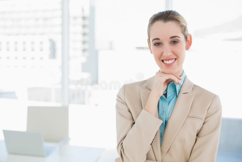 Schöne schicke Geschäftsfrau, die ihr Kinn berührend aufwirft lizenzfreies stockfoto Schöne schicke Geschäftsfrau, die ihr Kinn berührend aufwirft lizenzfreies stockfoto
