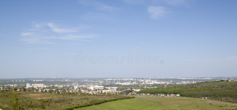 Beautiful summer view of a suburb of the city. Cloudless sky in the background. Beautiful summer view of a suburb of the city. Cloudless sky in the background