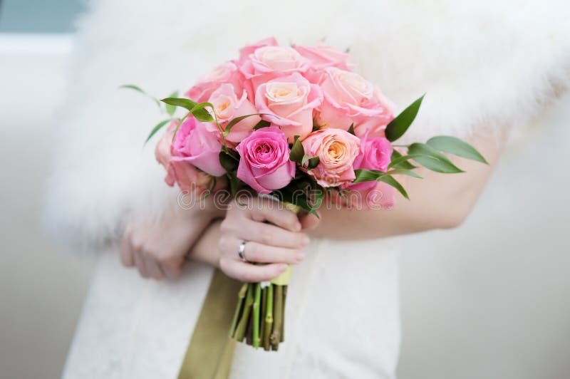 Bride holding beautiful wedding flowers bouquet. Bride holding beautiful wedding flowers bouquet