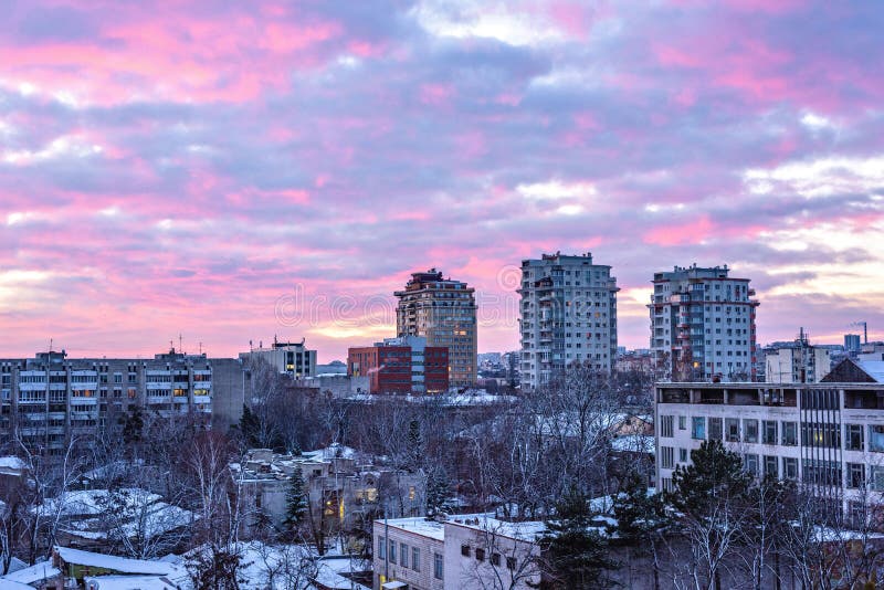 Beautiful sunset in Chisinau town. Warm light reflecting on buildings. Purple blue sky on background. Negative copy space, place for text. Moldova beauties. Beautiful sunset in Chisinau town. Warm light reflecting on buildings. Purple blue sky on background. Negative copy space, place for text. Moldova beauties