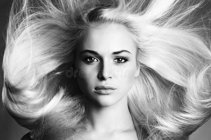 Beautiful Face of Young Woman. Blond girl. close-up. Art monochrome portrait. Beautiful healthy hair. Beauty salon. flying hair. Beautiful Face of Young Woman. Blond girl. close-up. Art monochrome portrait. Beautiful healthy hair. Beauty salon. flying hair