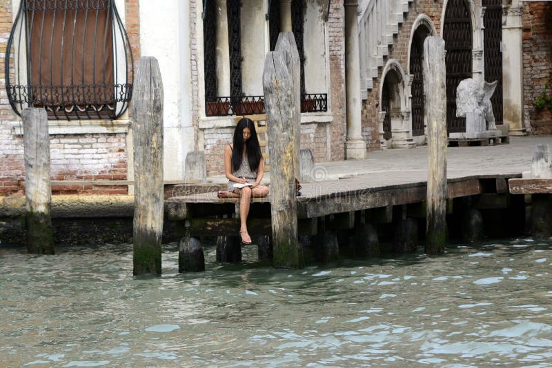 Schönes junges Asien-Frauenschreiben auf Notizbuch in Venedig, Sept. 8 lizenzfreie stockbilder Schönes junges Asien-Frauenschreiben auf Notizbuch in Venedig, Sept. 8 lizenzfreie stockbilder