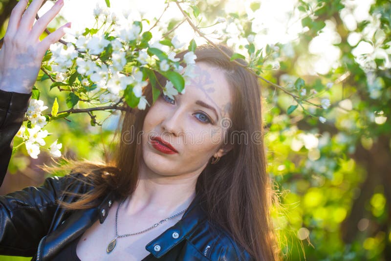 Schönes Mädchen unter dem florierenden Garten, blühen stockfotos