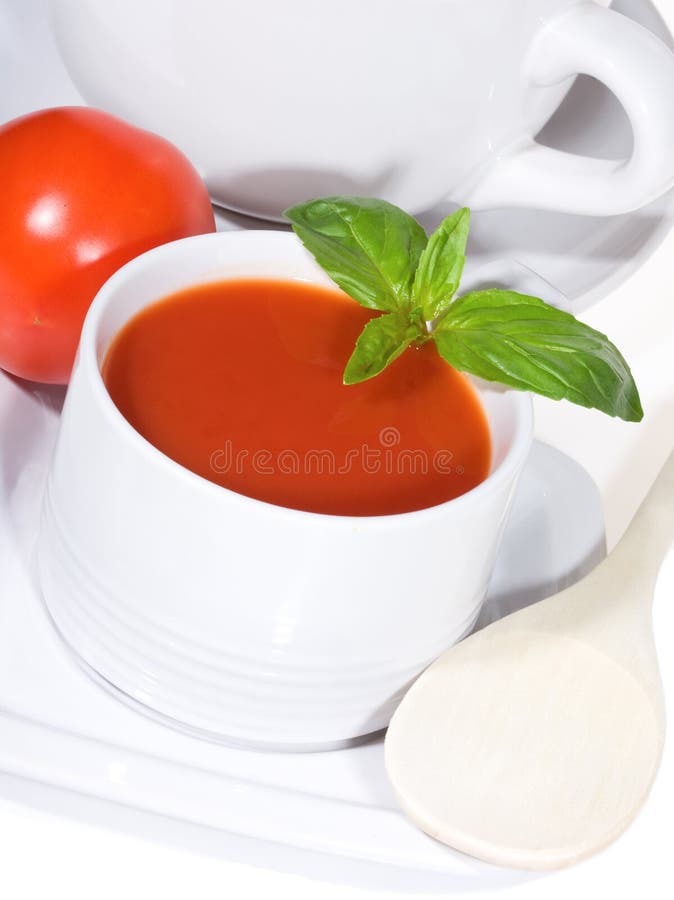 Bowls of delicious tomato soup with basil leaves. Bowls of delicious tomato soup with basil leaves
