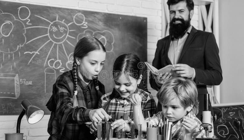 Science and education. chemistry lab. back to school. happy children teacher. children making science experiments. doing royalty free stock images Science and education. chemistry lab. back to school. happy children teacher. children making science experiments. doing royalty free stock images