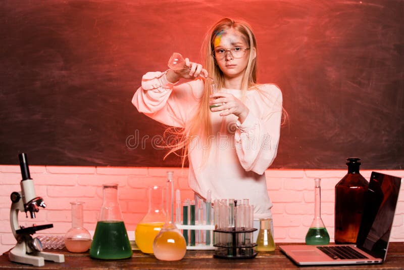 Science lab chemistry test. Funny little school child doing experiments in the laboratory. Explosion in the lab. Science and education. Little girl scientist in the laboratory. Chemical experiment