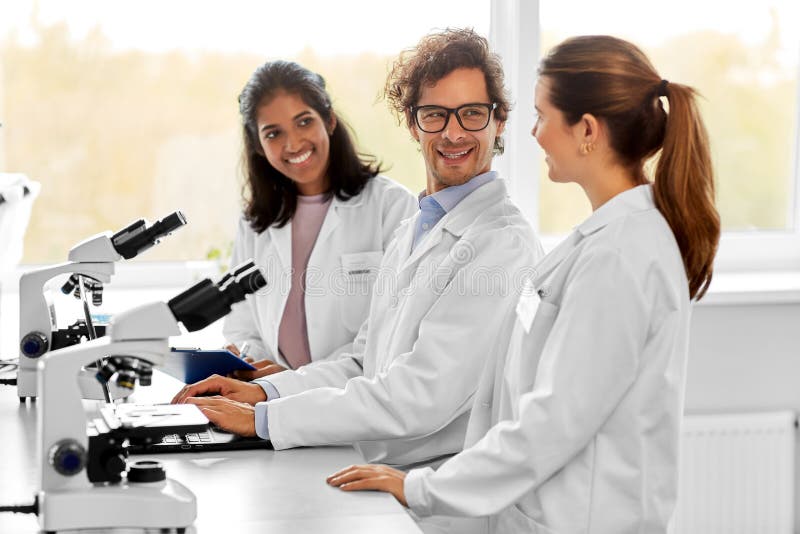 Scientists with microscopes working in laboratory royalty free stock photography