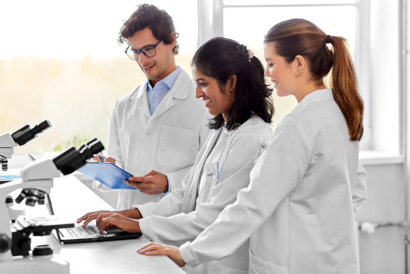 Scientists with microscopes working in laboratory stock photo