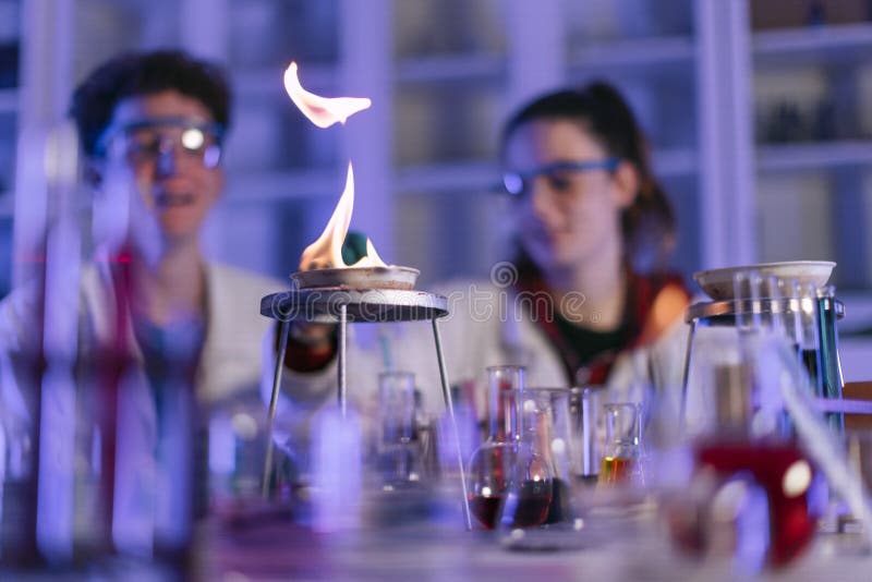 Science Students Doing Chemical Experiment in the Laboratory at