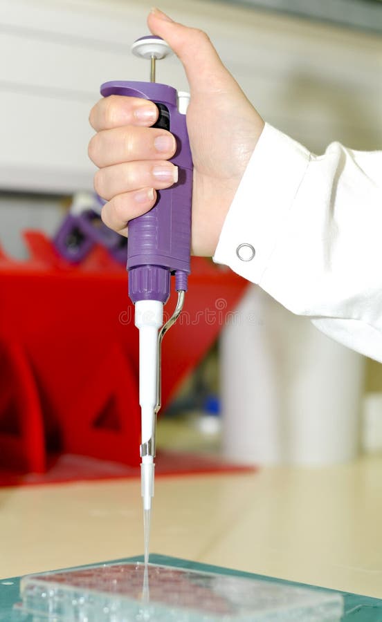 Sciencist Hand holding pipette