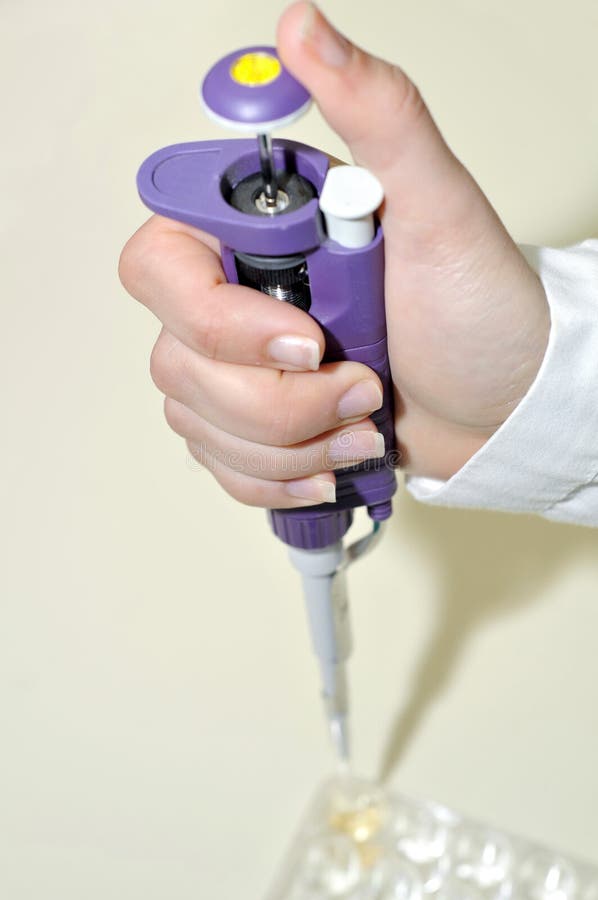 Sciencist Hand holding pipette