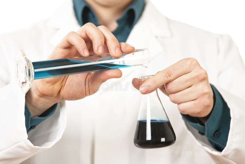 Scientiest pouring blue liquid stock photography