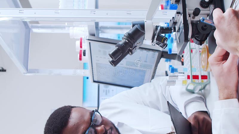 Scientific laboratory filled with various research equipment. Scientists are conducting experiments and research stock footage