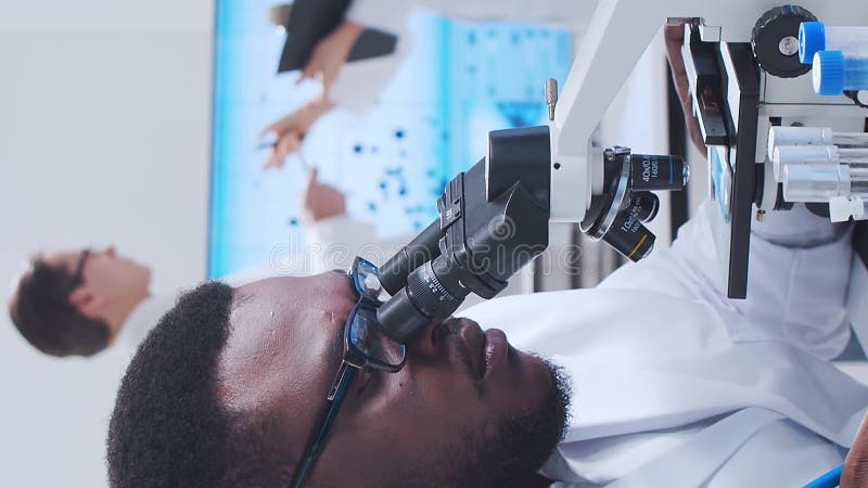 Scientific laboratory filled with various research equipment. Scientists are conducting experiments and research stock video footage