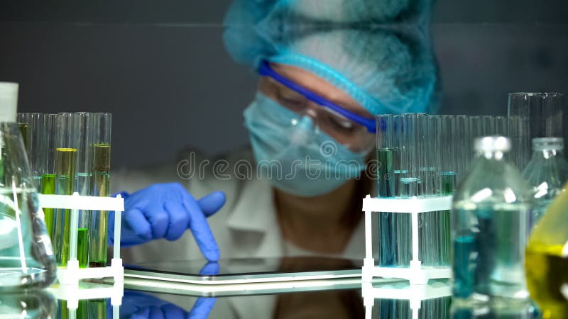 Scientist adding experiment results to tablet PC, modern equipment, laboratory royalty free stock photos Scientist adding experiment results to tablet PC, modern equipment, laboratory royalty free stock photos