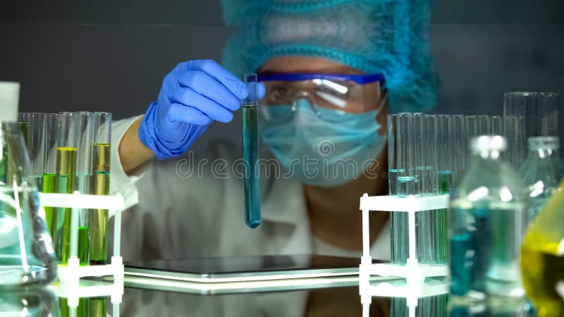 Scientist checking reaction in tube with water sample, pollution level control stock photos Scientist checking reaction in tube with water sample, pollution level control stock photos