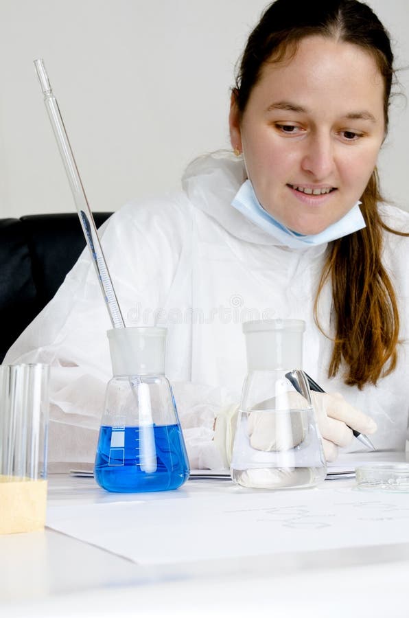 Scientist in a chemical lab writing